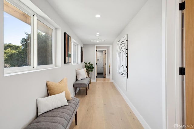 hallway with light hardwood / wood-style flooring