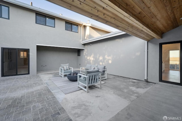 view of patio / terrace featuring an outdoor living space with a fire pit