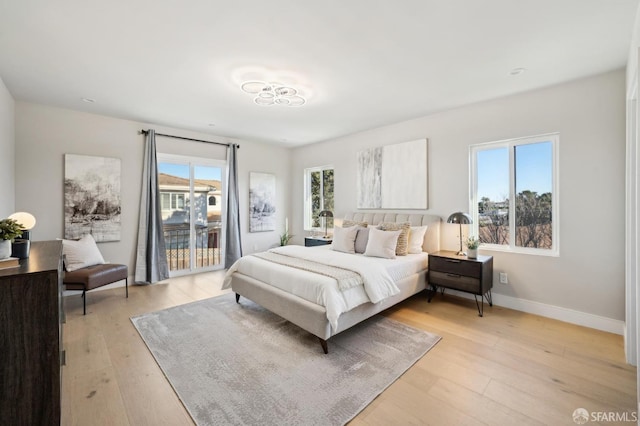 bedroom featuring light hardwood / wood-style flooring and access to outside