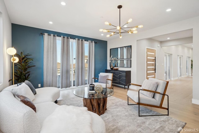 living room featuring light hardwood / wood-style floors and a notable chandelier