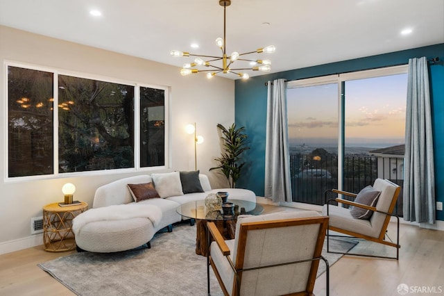 living room with a chandelier and light hardwood / wood-style flooring