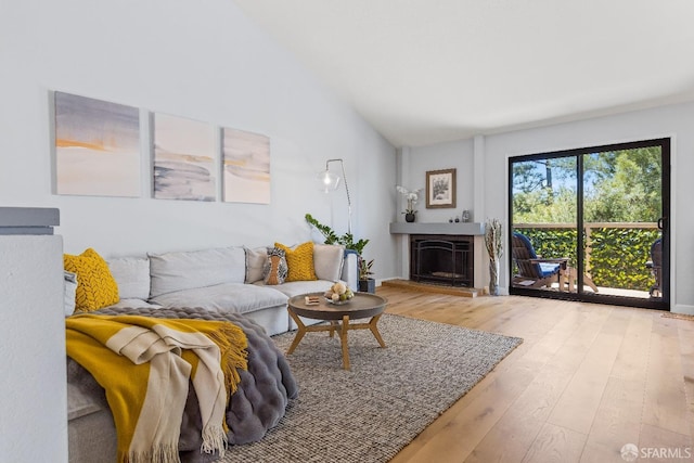 1541 Moraga Way, Moraga, CA 94556 - living area featuring wood finished floors, vaulted ceiling, and a fireplace with raised hearth