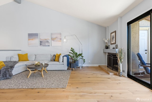1541 Moraga Way, Moraga, CA 94556 - living area featuring vaulted ceiling, wood finished floors, a fireplace with raised hearth, and baseboards