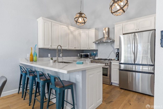 1541 Moraga Way, Moraga, CA 94556 - kitchen with stainless steel appliances, wall chimney exhaust hood, a sink, a peninsula, and white cabinetry