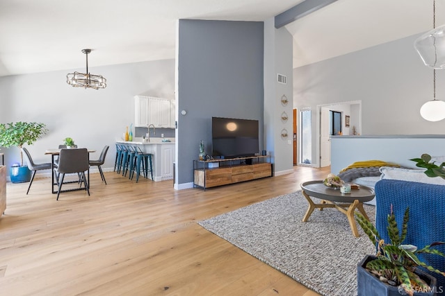 1541 Moraga Way, Moraga, CA 94556 - living room featuring high vaulted ceiling, a chandelier, light wood finished floors, baseboards, and beam ceiling