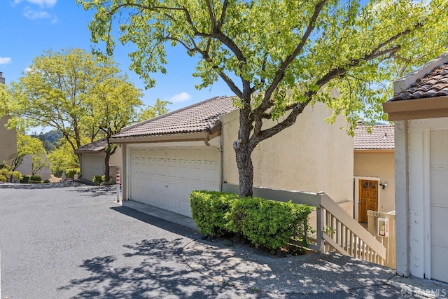 1541 Moraga Way, Moraga, CA 94556 - view of side of property with a tiled roof, stucco siding, and a garage