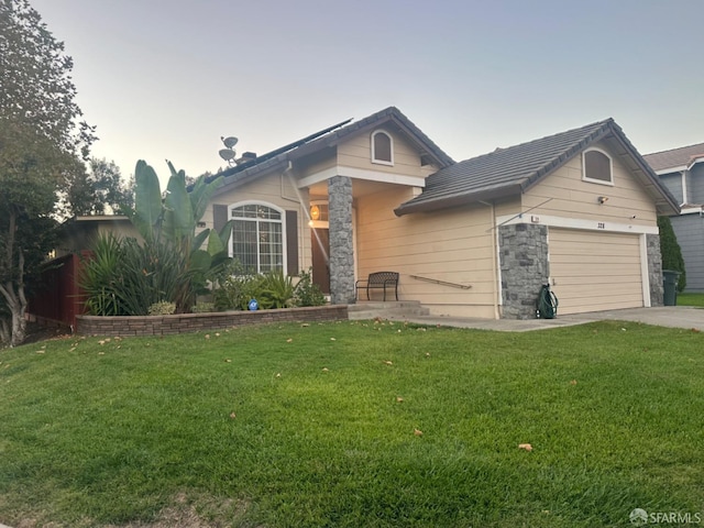 view of front of home featuring a garage and a front lawn