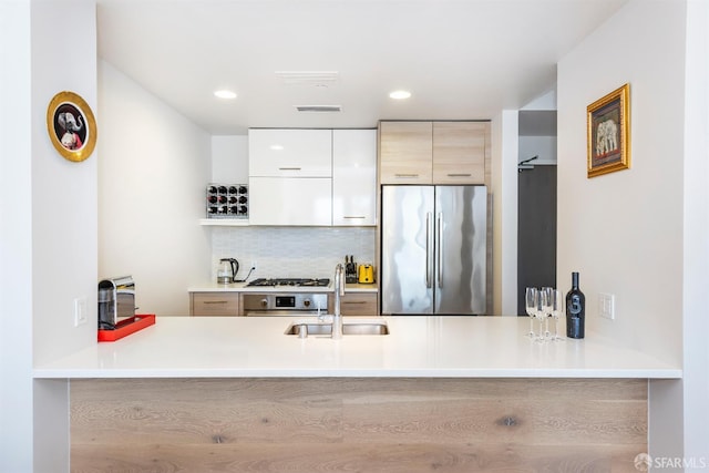 451 Donahue St Unit 207, San Francisco, CA 94124 - kitchen with stainless steel refrigerator, a sink, a peninsula, modern cabinets, and recessed lighting