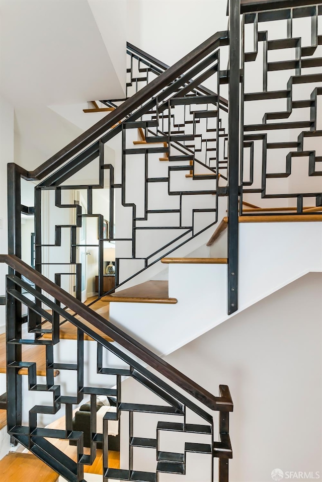 stairway featuring wood-type flooring