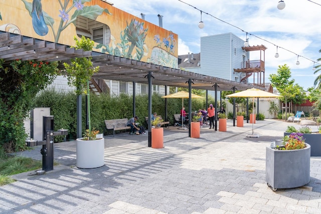 view of community featuring a pergola and a patio