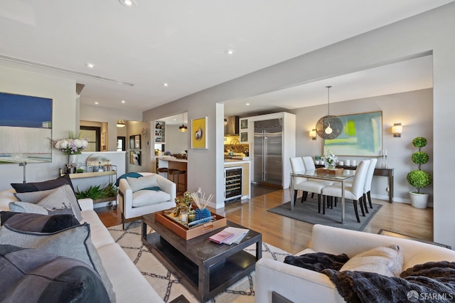 living room featuring light hardwood / wood-style floors and wine cooler