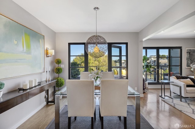 dining space with hardwood / wood-style floors