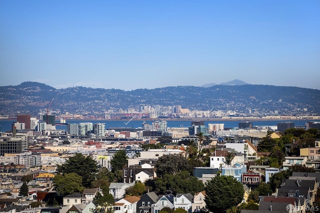 property's view of city featuring a water and mountain view