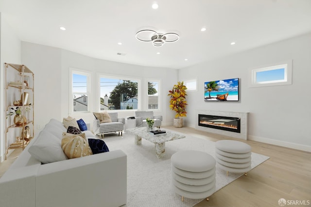 269 E Ave, San Bruno, CA 94066 - living area with light wood finished floors, a glass covered fireplace, plenty of natural light, and recessed lighting