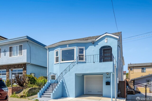 269 E Ave, San Bruno, CA 94066 - view of front of property with stucco siding, an attached garage, stairway, and driveway
