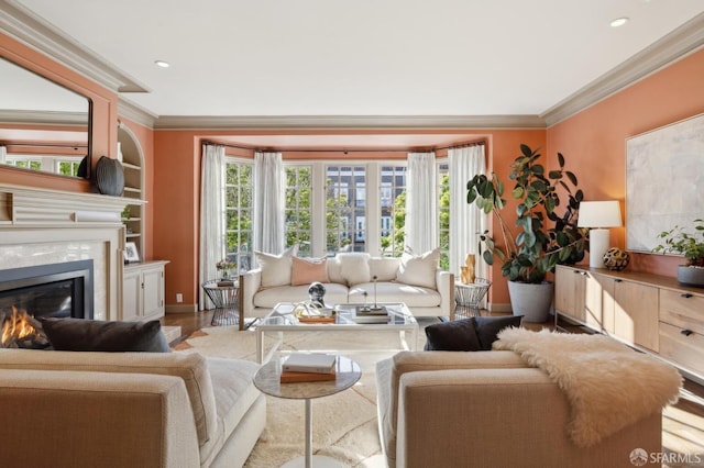 living area with a fireplace, a wealth of natural light, and crown molding