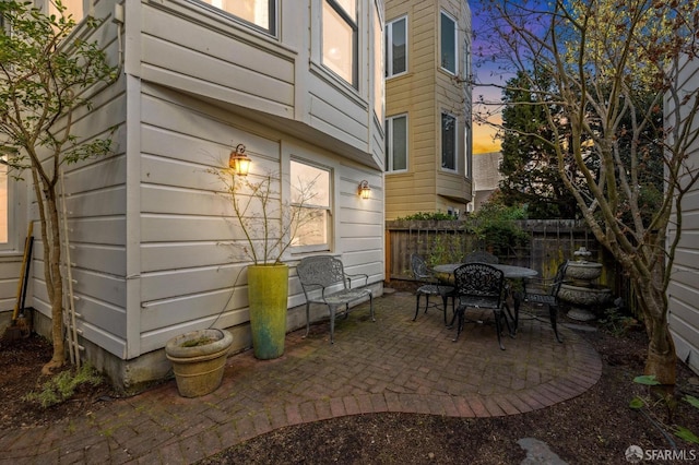 view of patio with fence and outdoor dining space