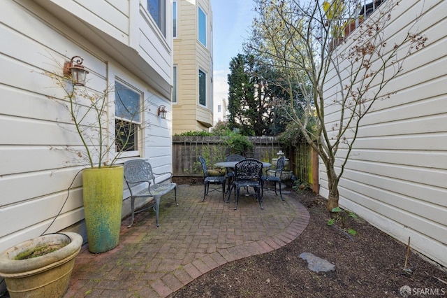 view of patio with outdoor dining space and a fenced backyard