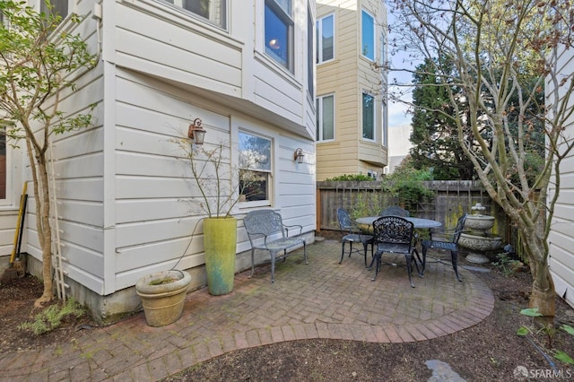 view of patio featuring outdoor dining space and a fenced backyard