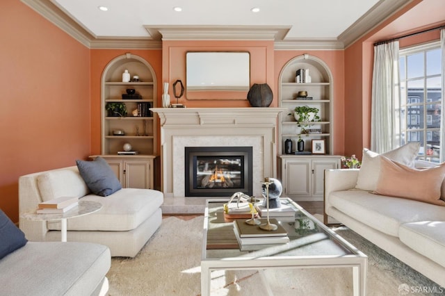 living room with built in features, crown molding, and a premium fireplace