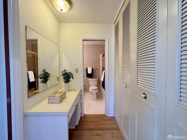 bathroom with vanity, toilet, and hardwood / wood-style floors