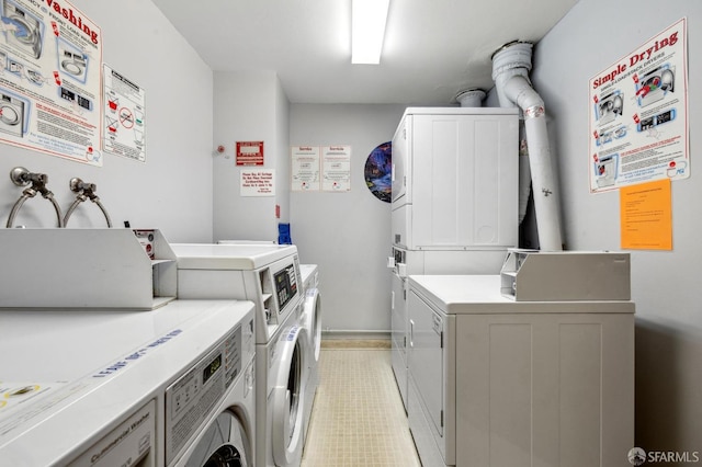 washroom with stacked washer and clothes dryer and independent washer and dryer