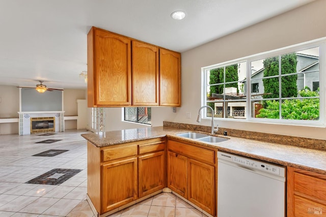 1001 Suffolk Way, Fairfield, CA 94533 - kitchen featuring white dishwasher, ceiling fan, light tile patterned floors, light stone counters, and a tile fireplace