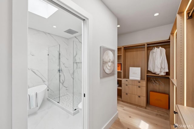 2287 45th Ave, San Francisco, CA 94116 - full bathroom with a marble finish shower, a freestanding tub, recessed lighting, wood finished floors, and a skylight