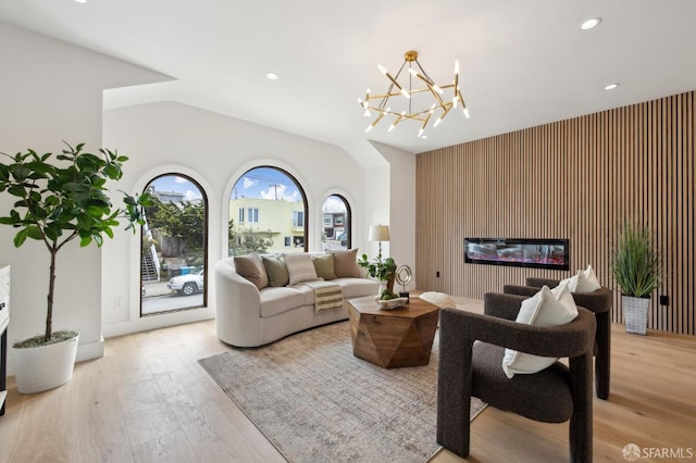 2287 45th Ave, San Francisco, CA 94116 - living room featuring light wood-style flooring, recessed lighting, an accent wall, a chandelier, and a glass covered fireplace