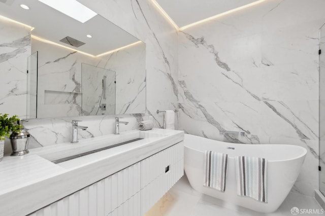 2287 45th Ave, San Francisco, CA 94116 - full bathroom with vanity, marble tiled flooring, a freestanding tub, stone wall, and recessed lighting