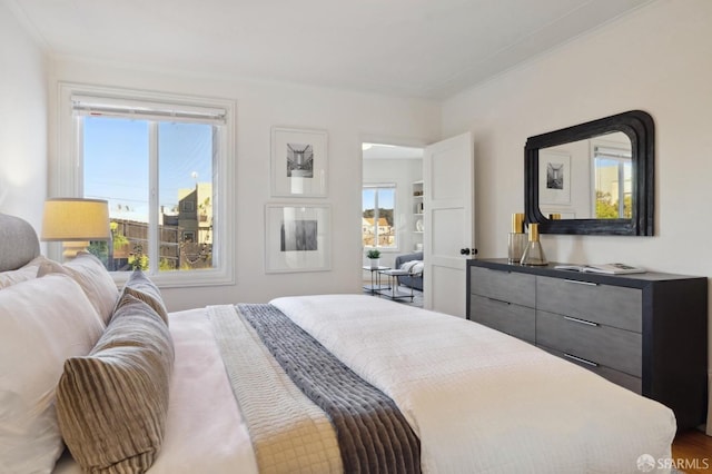 bedroom featuring crown molding and wood-type flooring