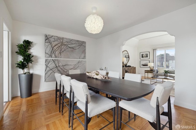 dining space featuring light parquet floors