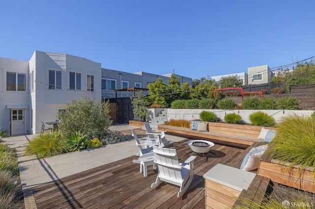 deck with a patio area and an outdoor fire pit