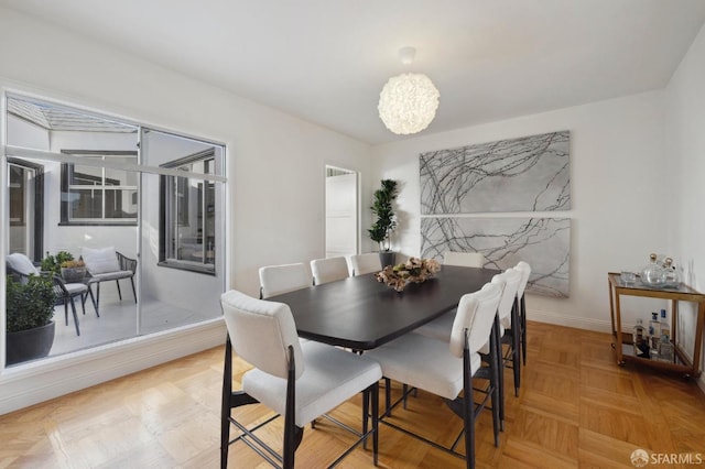 dining area with parquet flooring