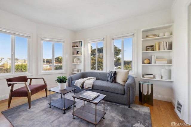 interior space featuring built in features and light hardwood / wood-style floors