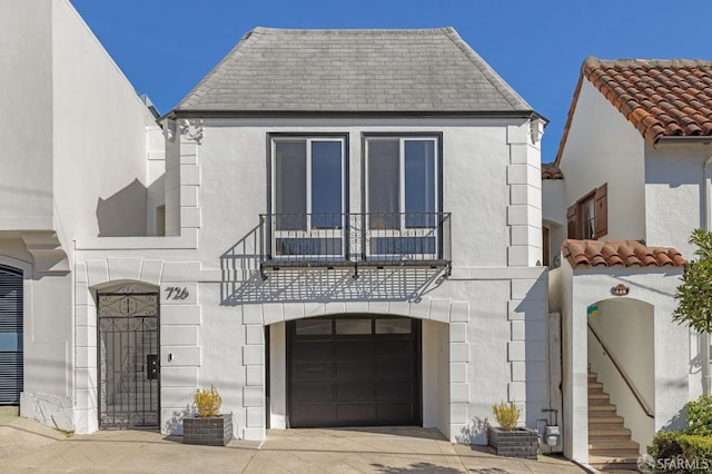 view of front of house with a garage and a balcony