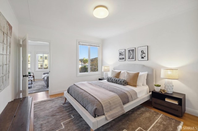 bedroom with dark hardwood / wood-style flooring