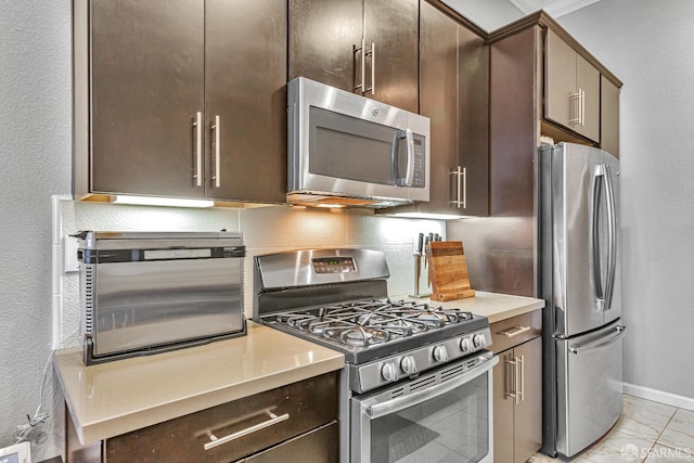 kitchen featuring tasteful backsplash, dark brown cabinetry, and stainless steel appliances