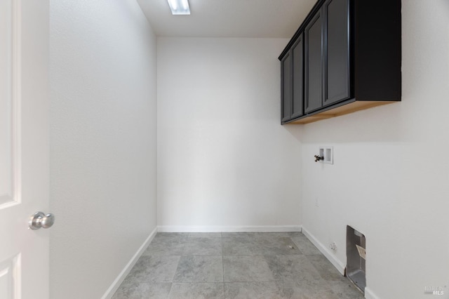 laundry area featuring washer hookup, baseboards, and cabinet space