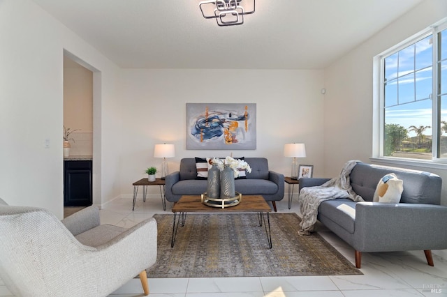 living room with a fireplace and marble finish floor
