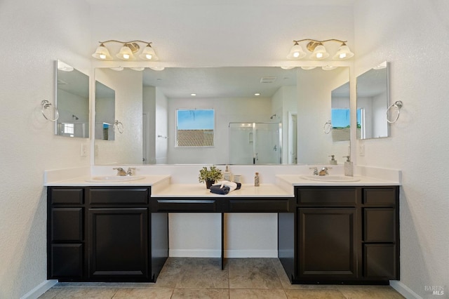 bathroom featuring double vanity, a sink, and a stall shower