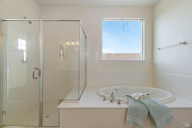 full bathroom featuring a garden tub and a stall shower