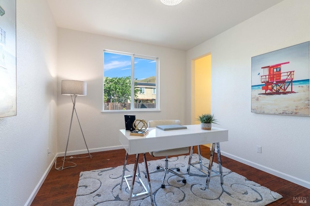 office area with baseboards and wood finished floors