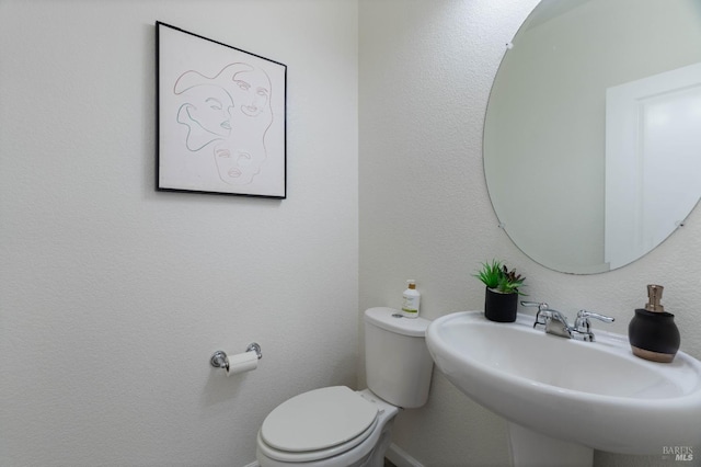 bathroom featuring toilet and a sink