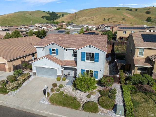 view of front of house with stucco siding, fence, a residential view, and concrete driveway