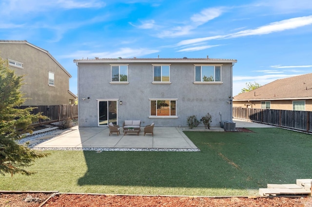 back of house featuring a lawn, a patio, an outdoor living space, and a fenced backyard