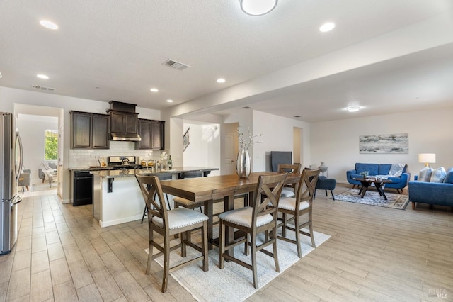 dining room featuring recessed lighting, visible vents, and light wood-type flooring