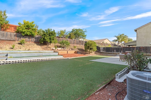 view of yard featuring a patio, central AC unit, and a fenced backyard