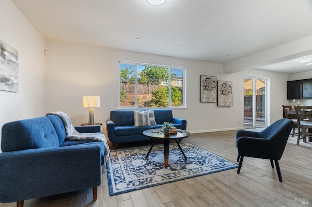living room with light wood-style floors and baseboards