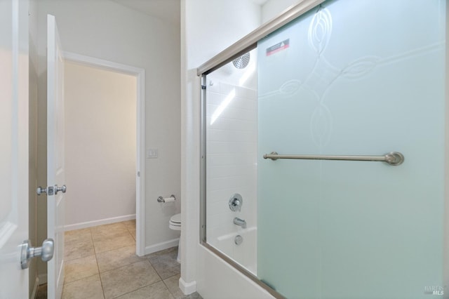 bathroom featuring baseboards, tile patterned flooring, toilet, and tub / shower combination